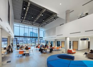 International students at Sheridan College discussing career opportunities and mentorship programs on campus. Colleges in Canada with Paid Internships