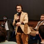 A man speaking with mic in his hand