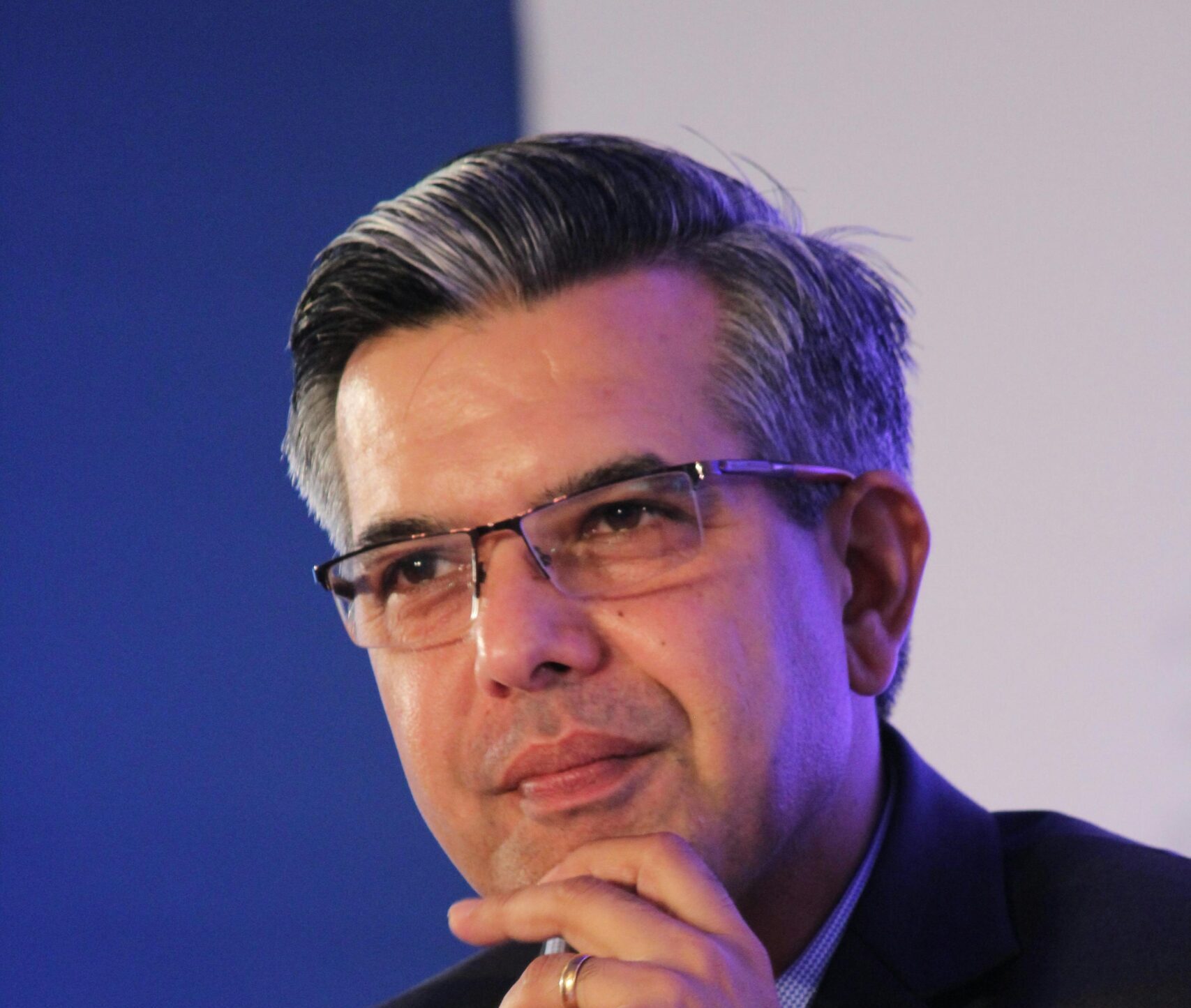 Corporate shot of a man in suit with his fingers on his chin
