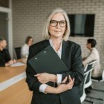 corporate shot of a woman holding a file