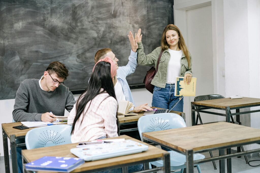 College students gathered in a classroom and doing discussions while sitting on the bench